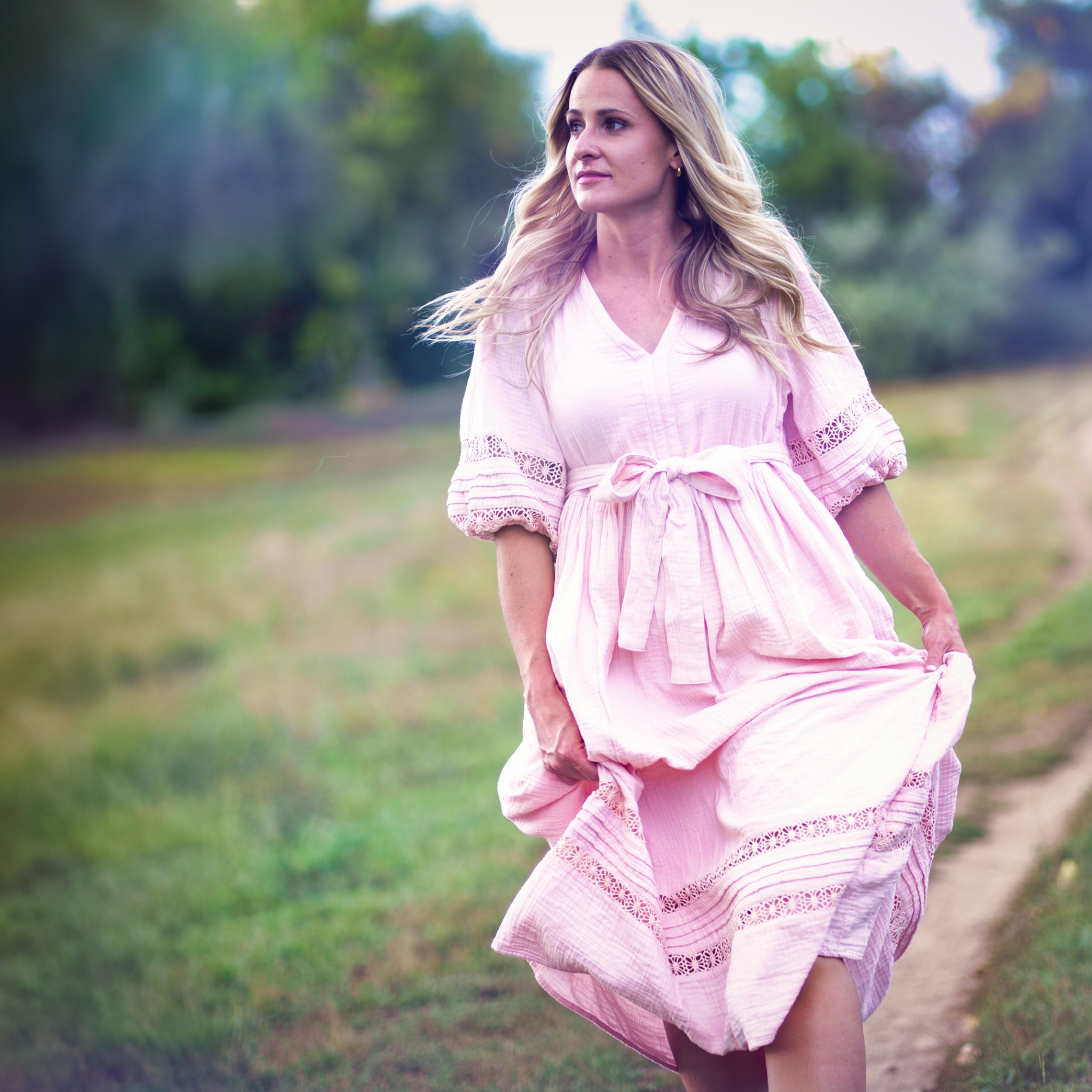 Lindsay Pratt in a pink dress on a windswept summer path