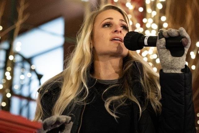 Lindsay Pratt singing at a winter performance